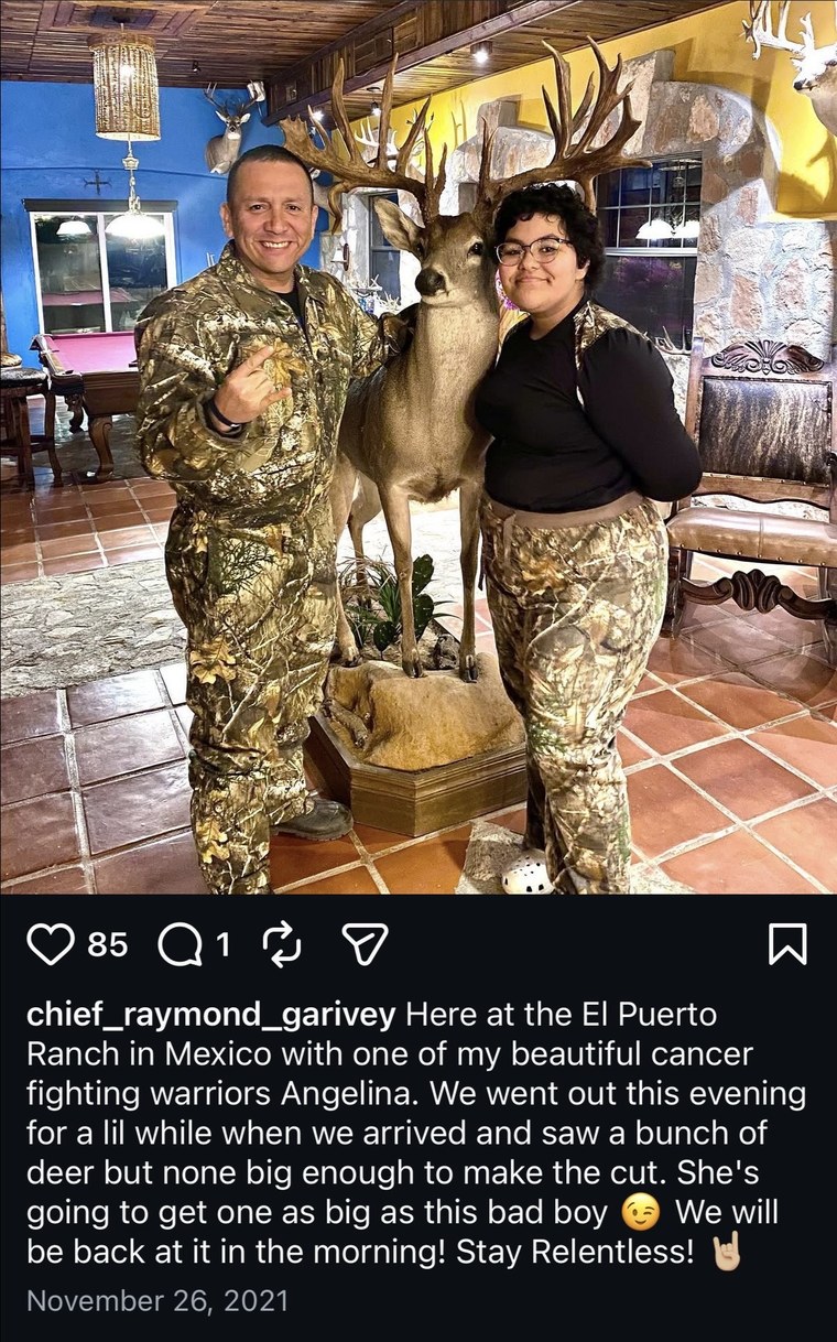 Guests posing with a mounted trophy mule deer